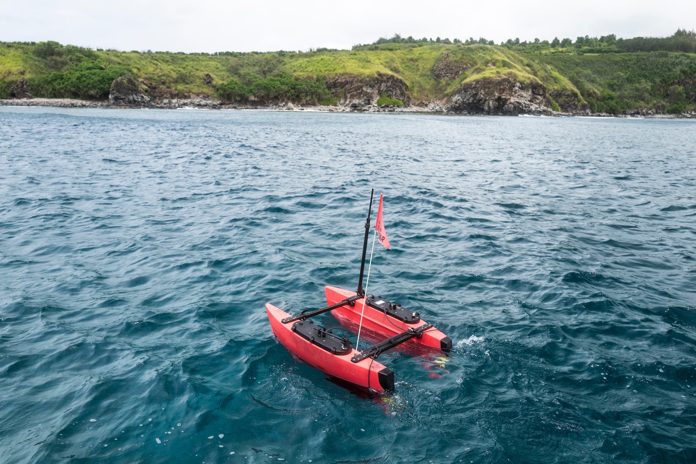 a red robotic boat in honolua bay